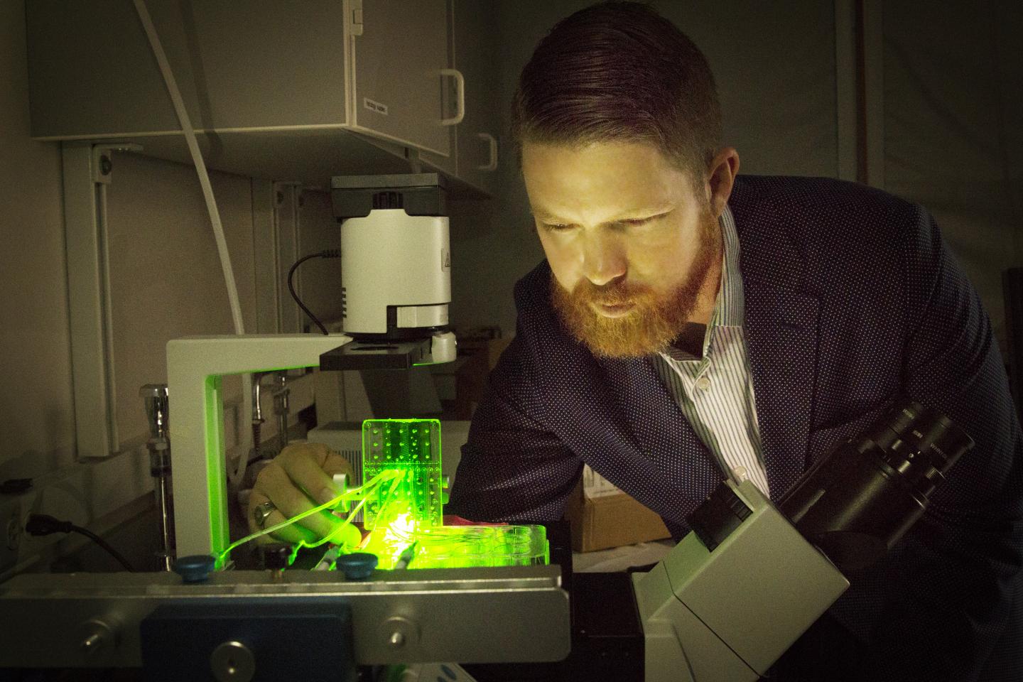 University of Utah biomedical engineering assistant professor Robby Bowles with a customised 3D bioprinter. Photo via Dan Hixson/University of Utah College of Engineering.
