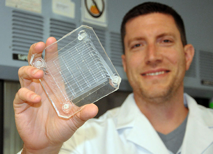 Biomedical engineer Dr. Joseph Potkay, with the VA Ann Arbor Health Care System, displays a 2D prototype of an artificial lung. A 3D version is in production. Photo by Brian Hayes/VA