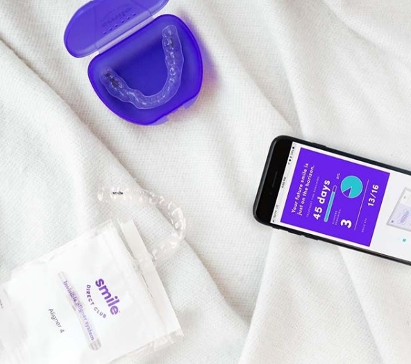 A custom clear aligner is delivered to a customer's home and the teeth-straightening process can be tracked via SmileClubDirect's app. Photo via SmileDirectClub.