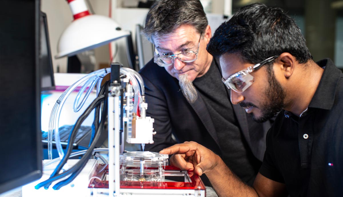 UOW researchers with the 3D Alek bioprinter. Photo via UOW.